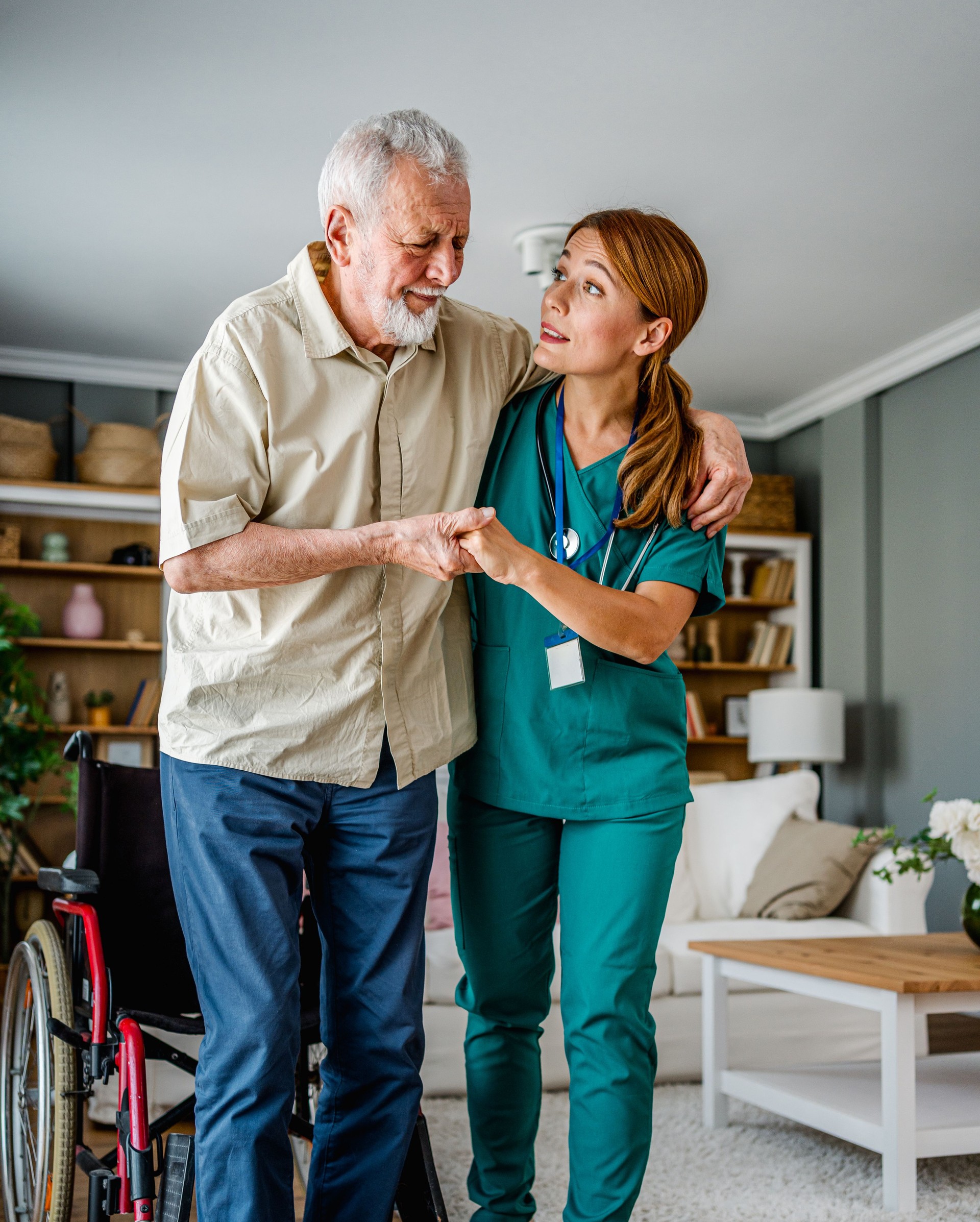 Female nurse supporting senior man to walk